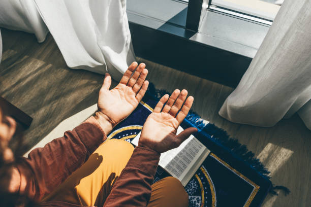 Muslim man praying in a hotel while traveling.